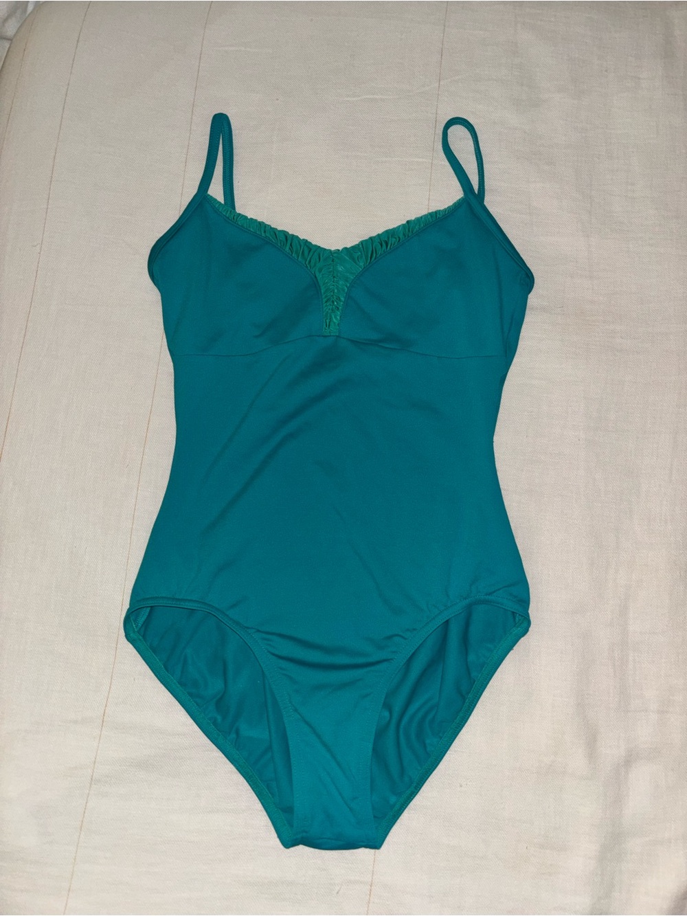 Women's teal ballet leotard with lace ruffle v-neck detail